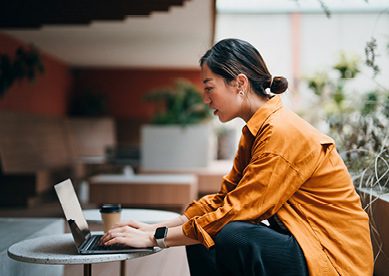 Image of young Asian woman on laptop